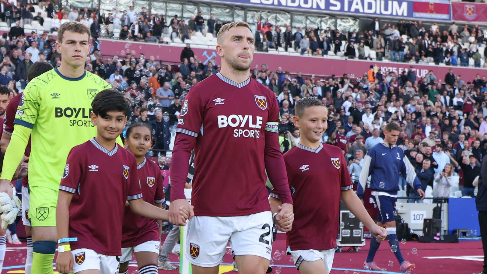 Archie (right) leads the Hammers out with Jarrod Bowen